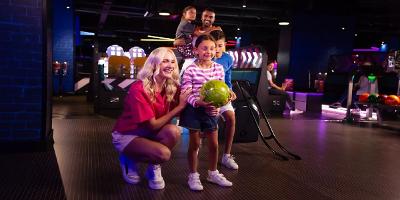 A family getting ready to throw a bowling ball at Hollywood Bowl